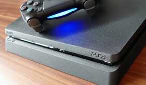 front of a playstation 4 with a controller on top, spine emulates the playstation 4
