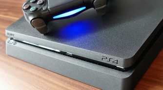 front of a playstation 4 with a controller on top, spine emulates the playstation 4