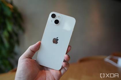 An iPhone 13 in the hand. 