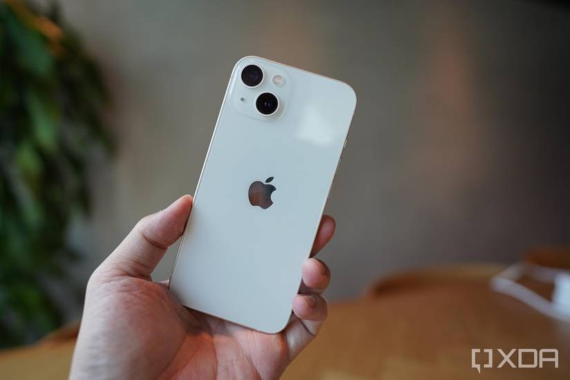 An iPhone 13 in the hand. 