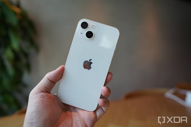 An iPhone 13 in the hand.