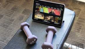 Purple dumbbells and iPad mini with Apple Fitness+