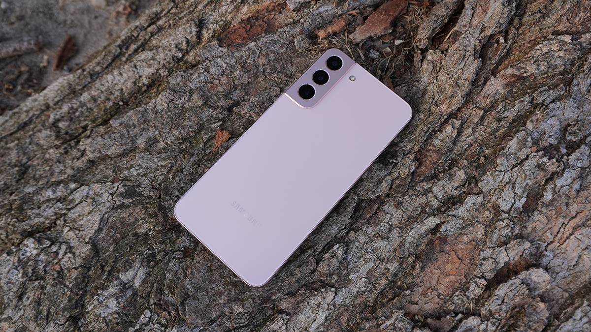 A Samsung Galaxy S22 Plus showng from the back lying on a tree