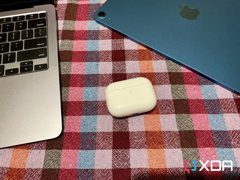 AirPods Pro closed case next to MacBook Air M1 and iPad Air 5