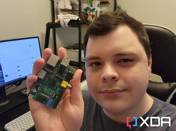 Selfie photo holding up a Raspberry Pi