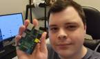 Selfie photo holding up a Raspberry Pi