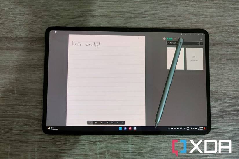 Overhead view of the HUAWEI MateBook E with the M-Pencil resting on the display and handwritten text reading "Hello World"