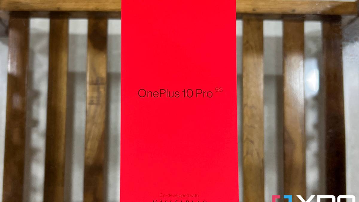 Red box of the OnePlus 10 Pro kept on a wooden table with glass top