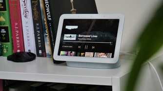 Google Nest Hub 2nd Generation on a white shelf with books
