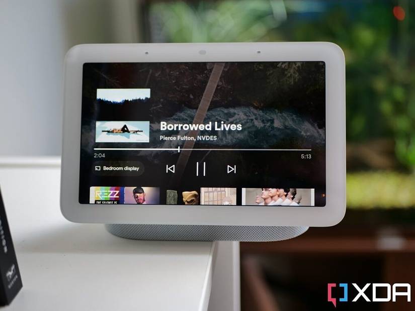 Google Nest Hub 2nd Generation on a white shelf with an aquarium in the background