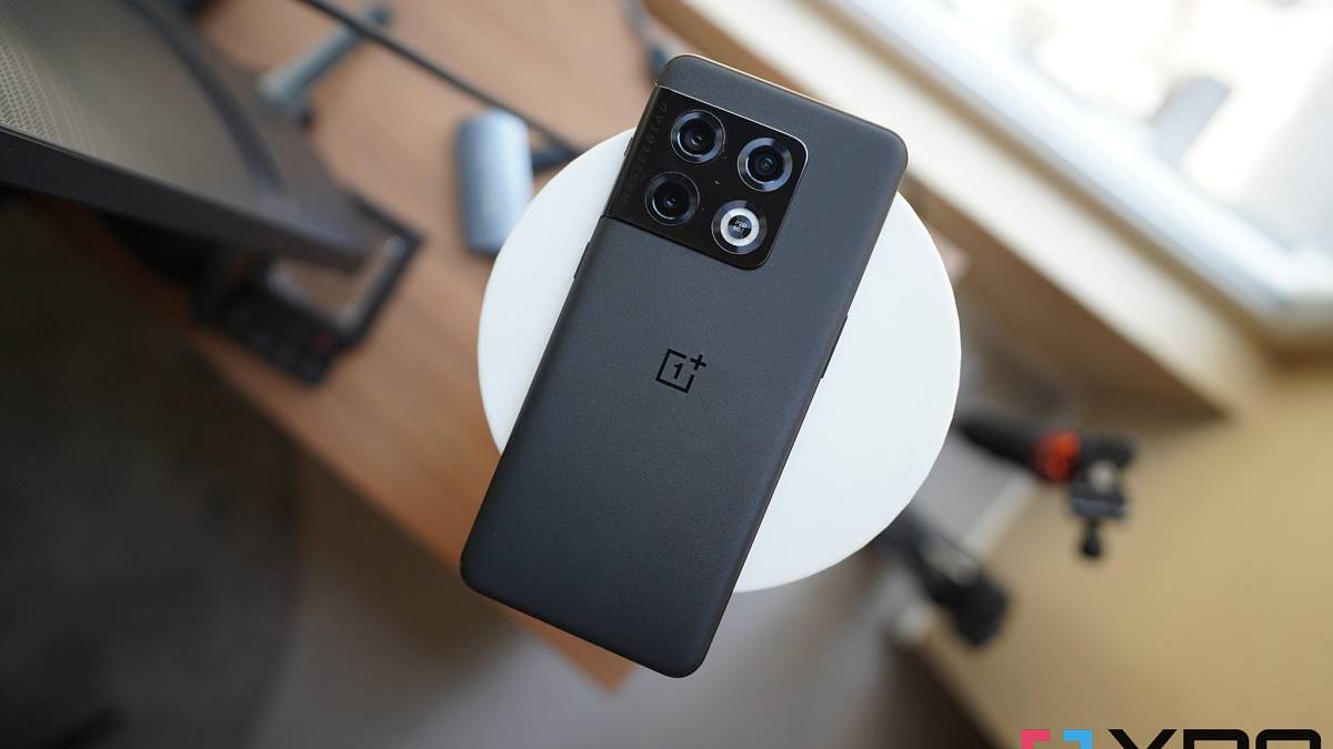 Black OnePlus 10 Pro on white surface with blurred background.