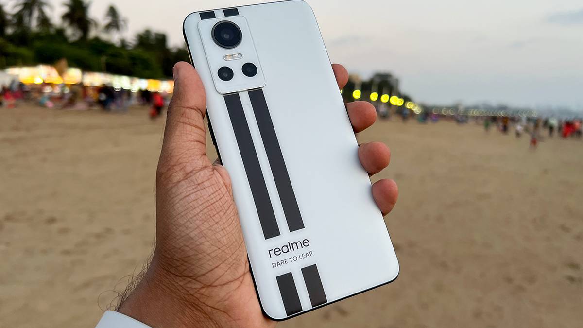 Realme GT Neo 3 in White color against the backdrop of a beach