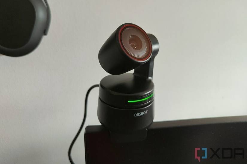 Obsbot Tiny 4K webcam pointing up with green lights indicating that tracking enabled