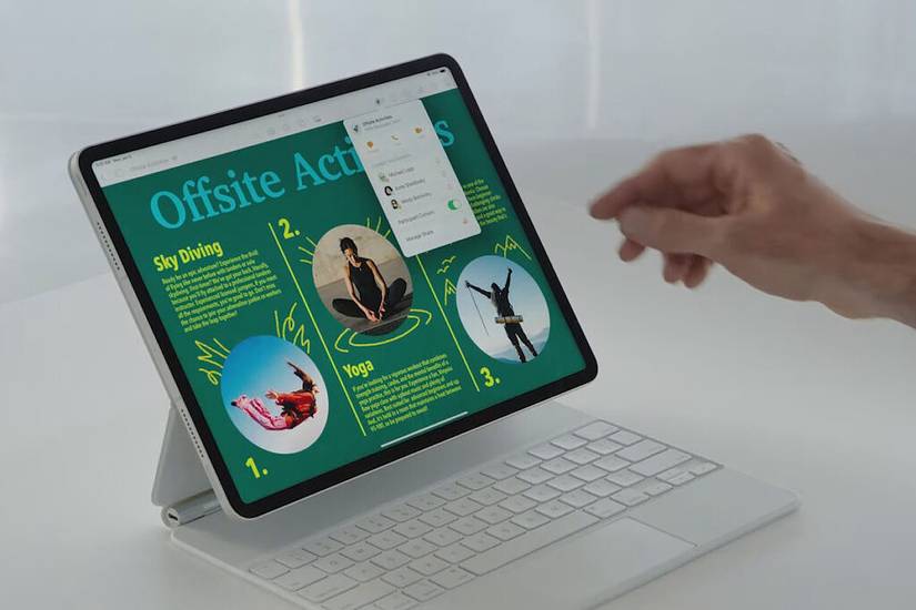 A man's hand interacts with an iPad.