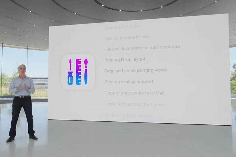Craig Federighi stands in front of a presentation board.