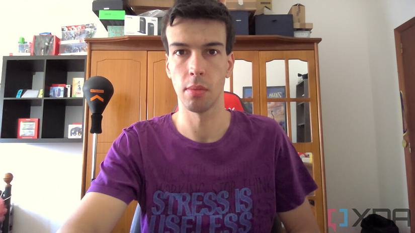 Camera sample from the Acer Swift 3 laptop webcam. It depicts a man sitting on a chair with furniture behind him.
