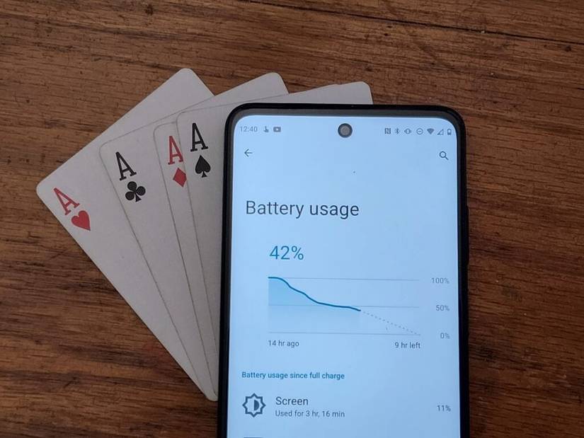 The Moto G Stylus 5G lined up in a hand of cards.