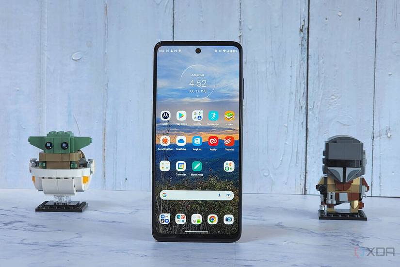 The Moto G Stylus 5G stands on a table with two lego minifigs.