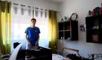 A picture of a man standing in front of a window with strong sunlight outside. Some shapes can be seen outside the window. The image is a sample taken from a video recorded with the Insta360 Link webcam