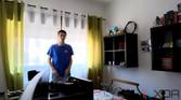 A picture of a man standing in front of a window with strong sunlight outside. Some shapes can be seen outside the window. The image is a sample taken from a video recorded with the Insta360 Link webcam