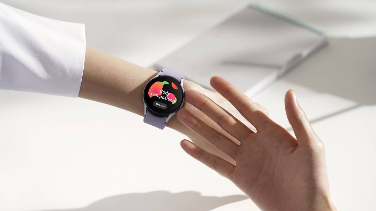 A person taking Body Composition measurement on their Galaxy Watch 5 by touching the side of the watch using their fingers