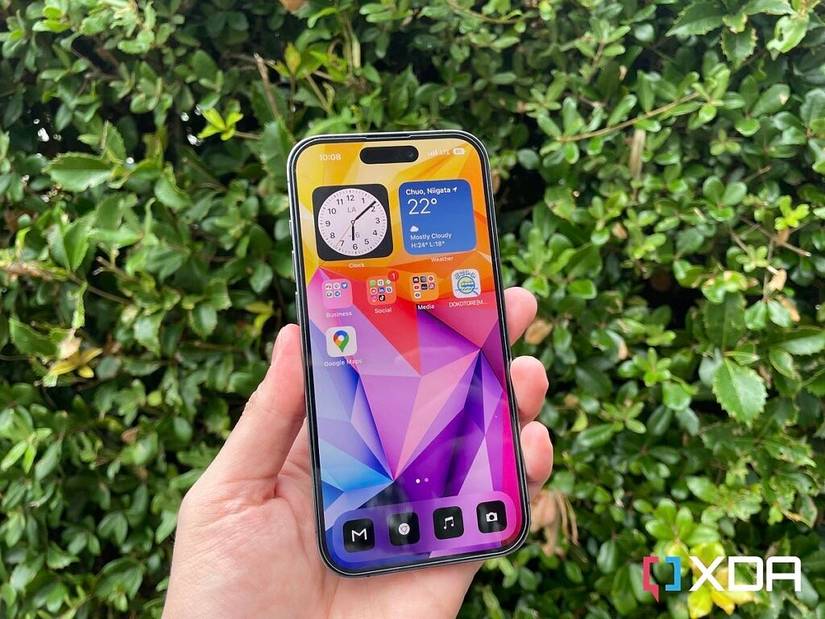 iPhone 14 Pro in front of bushes 