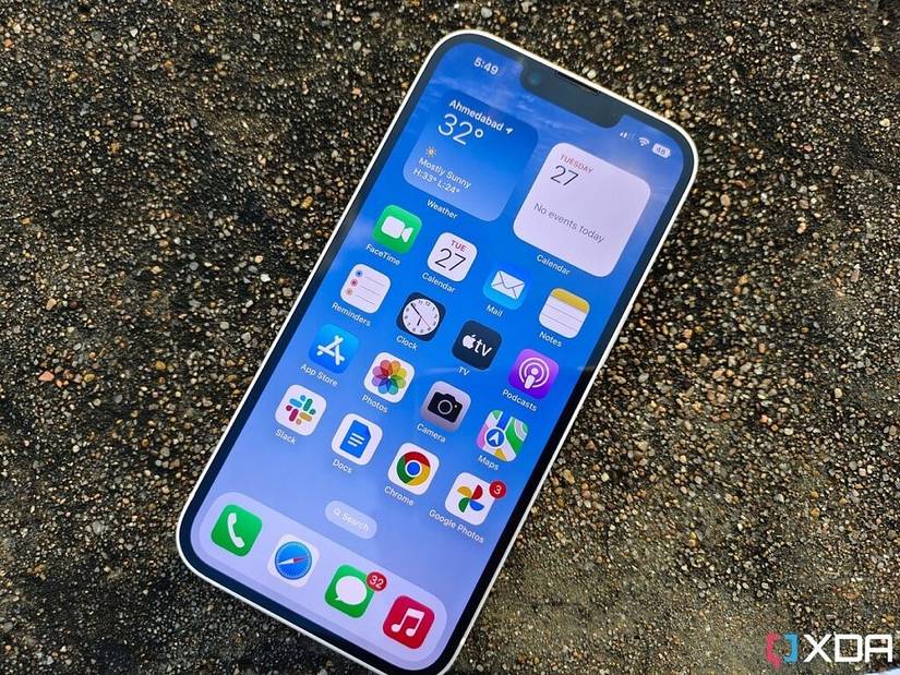iPhone 14 laying on a flat surface displaying home screen