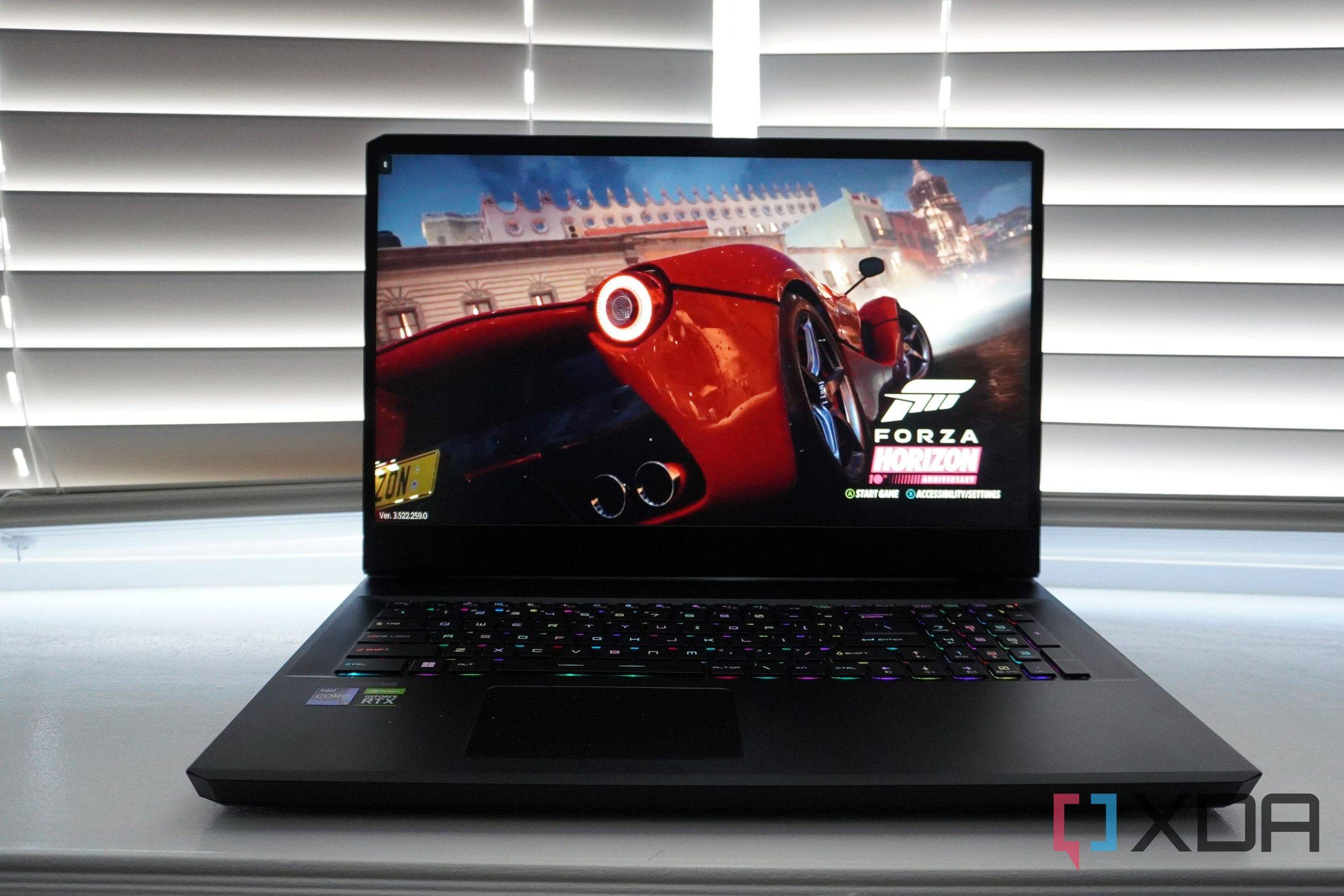MSI Gaming laptop on a desk in front of blinds