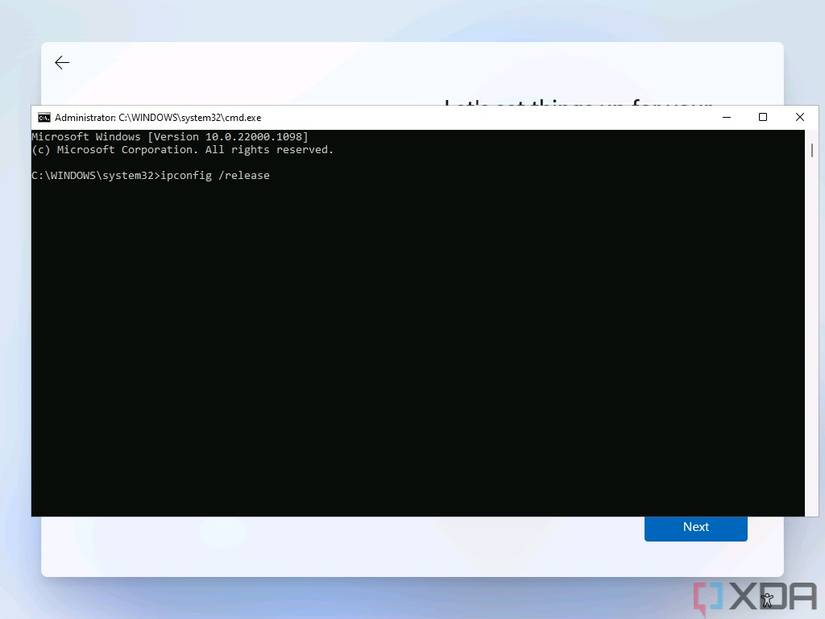 Screenshot of Command Prompt open over the Windows 11 setup experience with the command to disable the internet connection