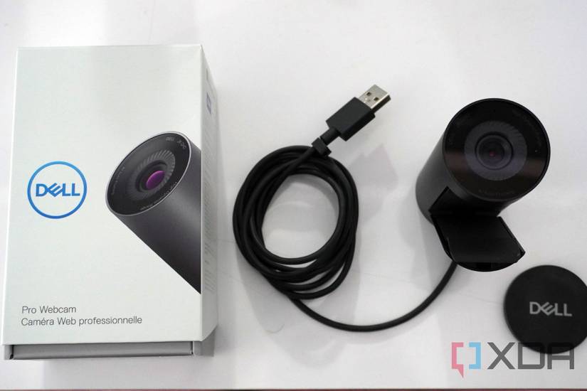 The Dell Pro Webcam and the box, opened up with accessories.