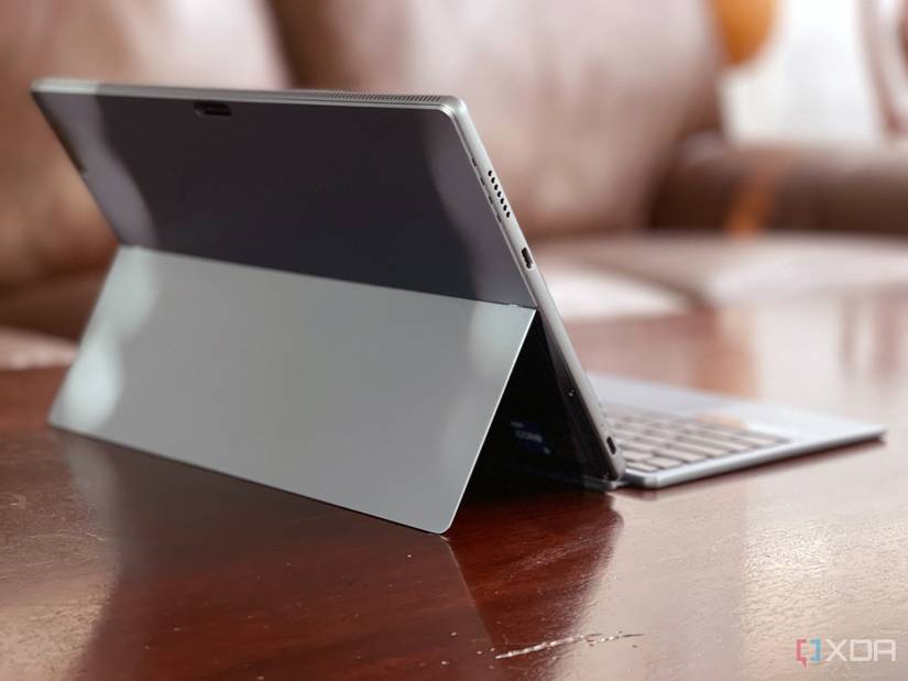 The IdeaPad Duet 5i from the rear, sitting on a table with sofa in back.