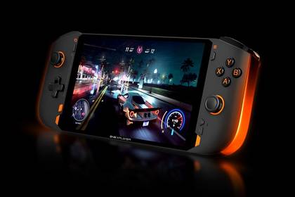 Amgled view of a portable gaming console with a 7-inch screen. On the left side of the screen, there's an analog stick and a D-pad, and on the right, a second analog stick and a set of four buttons labeled A, B. X, and Y. The side edges of the device are illuminated with an orange light.