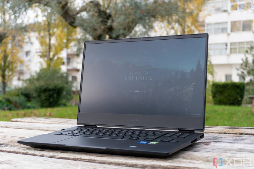 Angled front view of the Omen 16 with the camera placed at the same height as the keyboard. The display can be seen showing the title screen for Halo Infinite