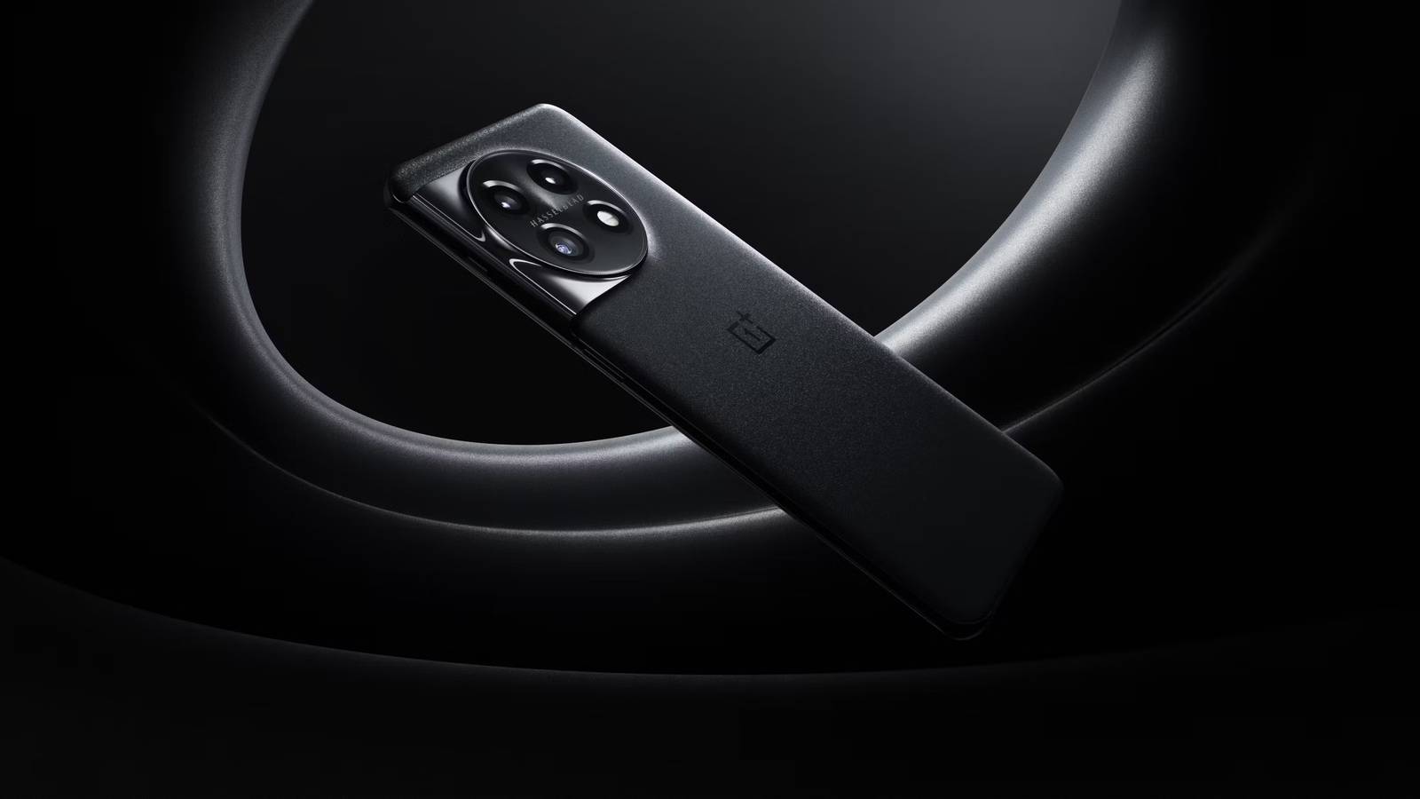OnePlus 11 in black on stylized black and gray background.