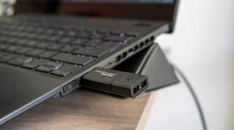 Close-up view of a USB flash drive plugged into a Windows 11 laptop