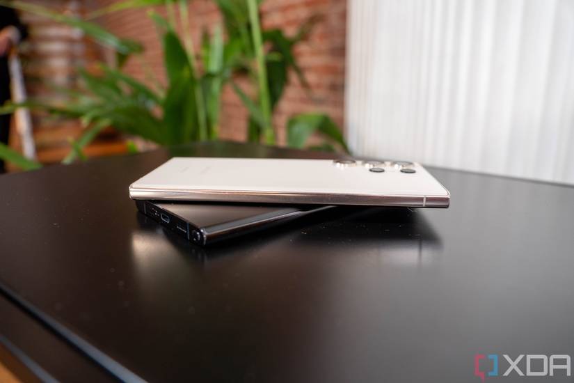 White smartphone on top of black smartphone