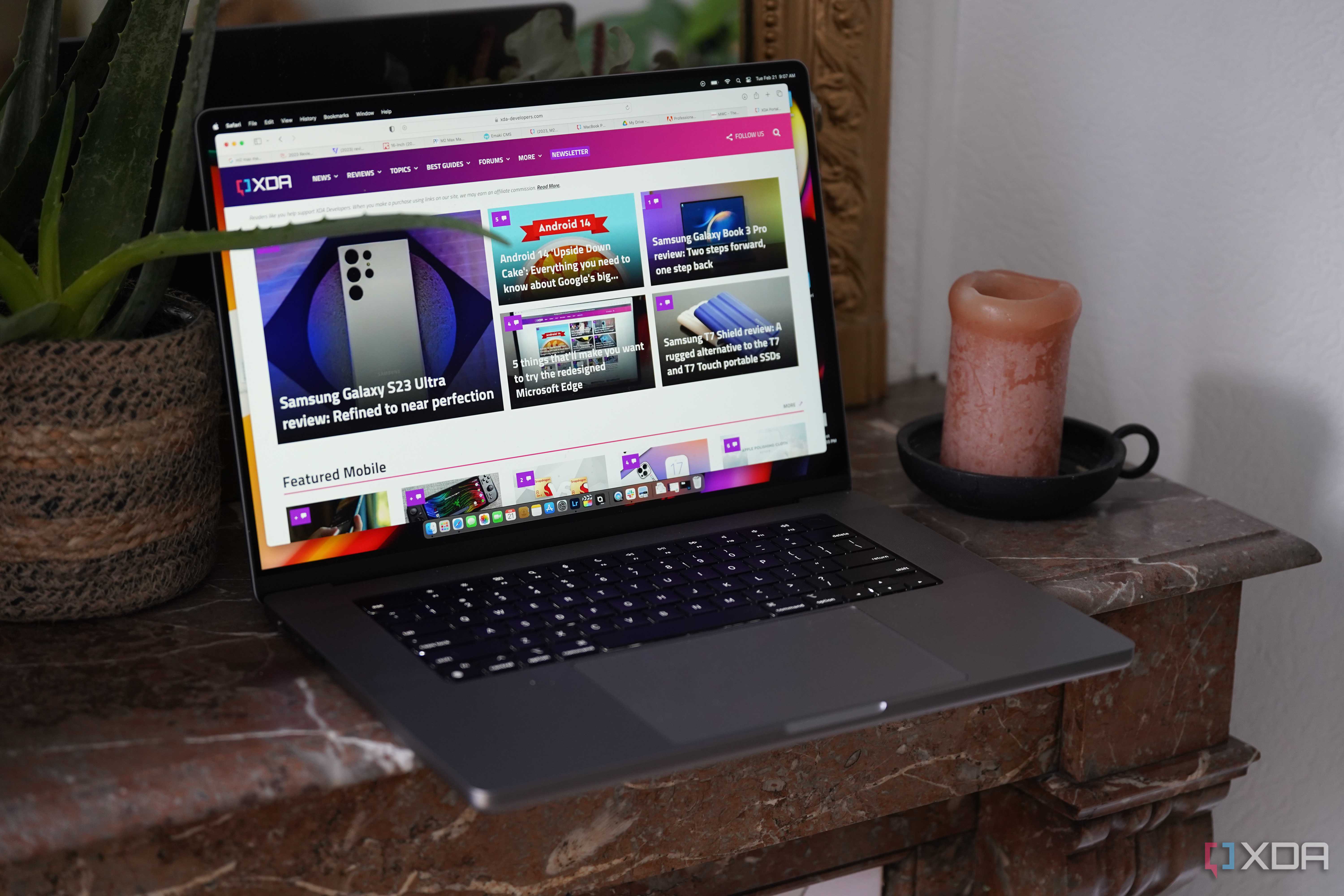 The MacBook Pro M2 Max on a table with the XDA website on the display