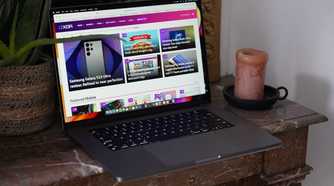 The MacBook Pro M2 Max on a table with the XDA website on the display