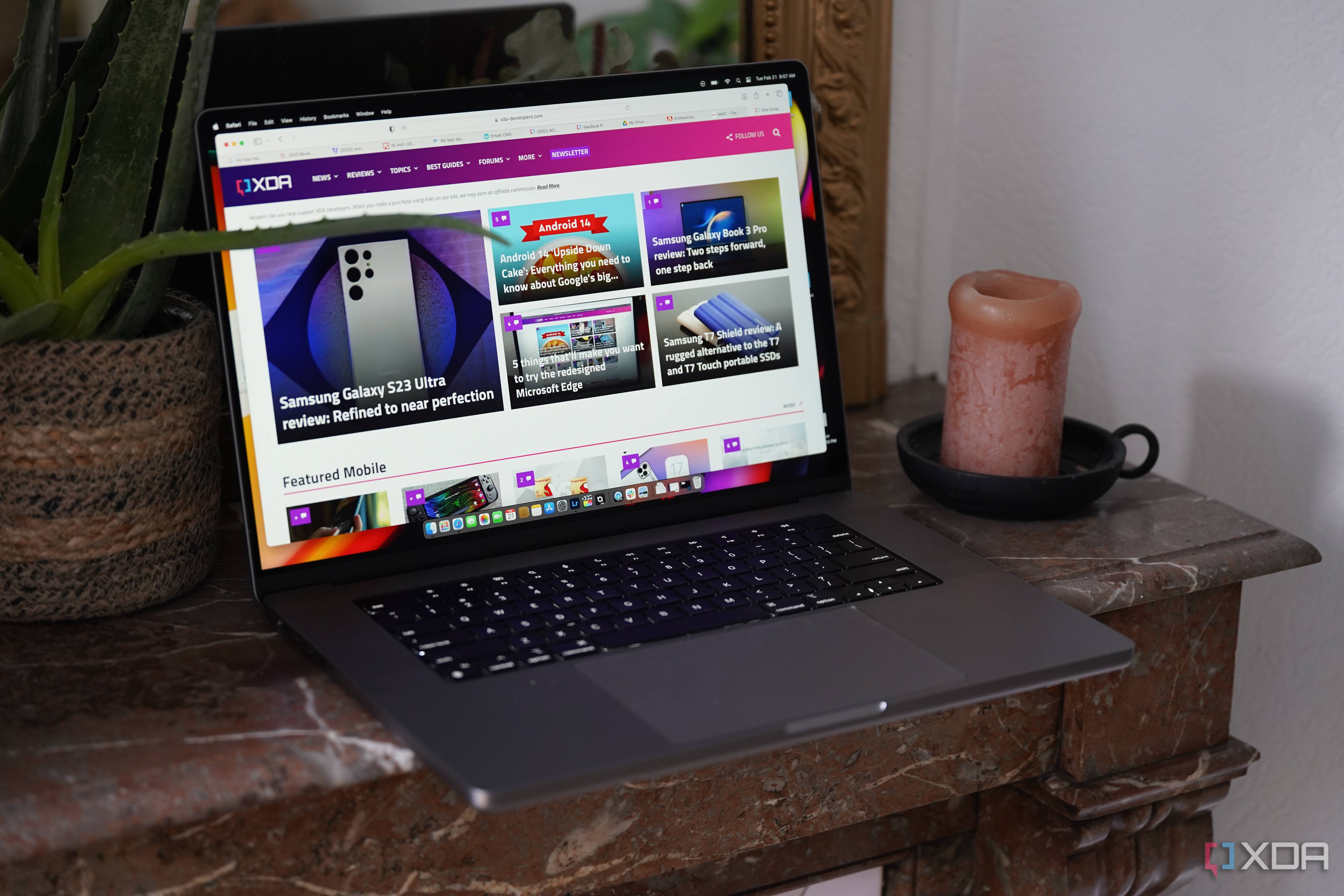 The MacBook Pro M2 Max on a table with the XDA website on the display