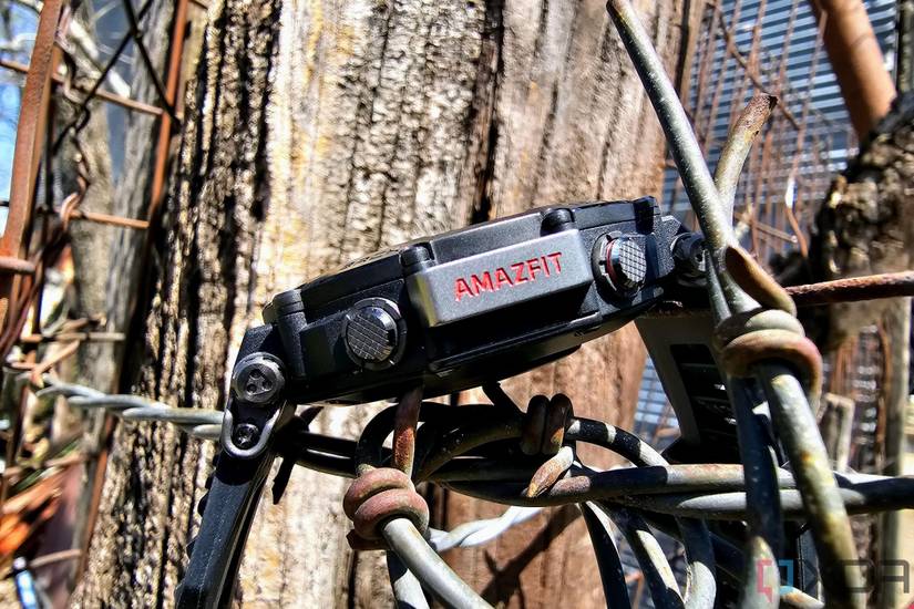 Amazfit T-Rex Ultra from the side sitting on barbed wire