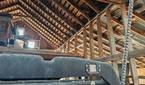 Photo inside of a barn roof rafters