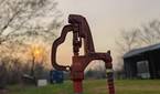 Portrait photo of a water hydrant at sunset with background blur turned on