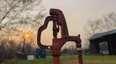 Portrait photo of a water hydrant at sunset with background blur turned on