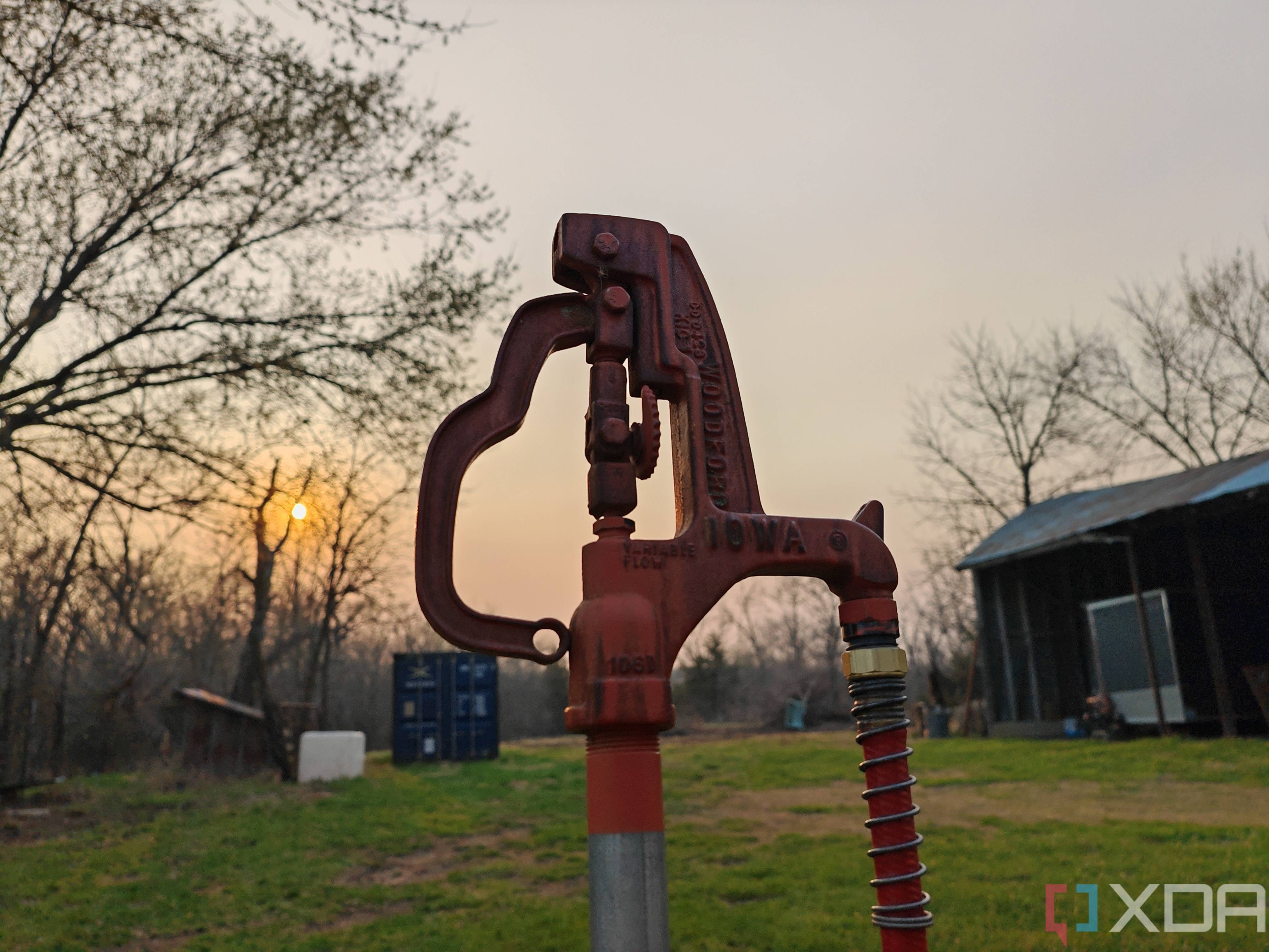 Portrait photo of a water hydrant at sunset with background blur turned off