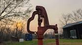 Portrait photo of a water hydrant at sunset with background blur turned off