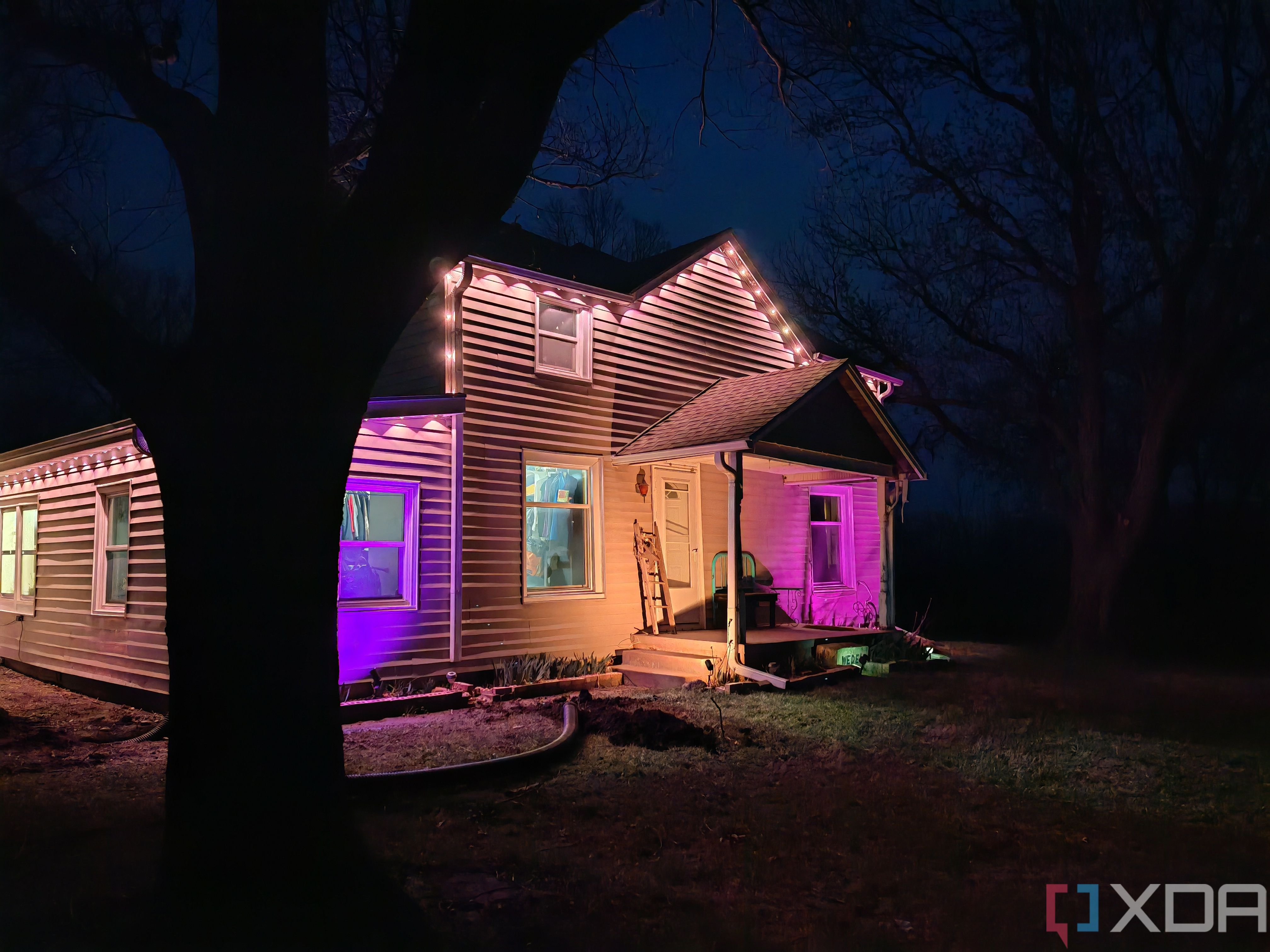 Photo of a house at night with exterior lighting