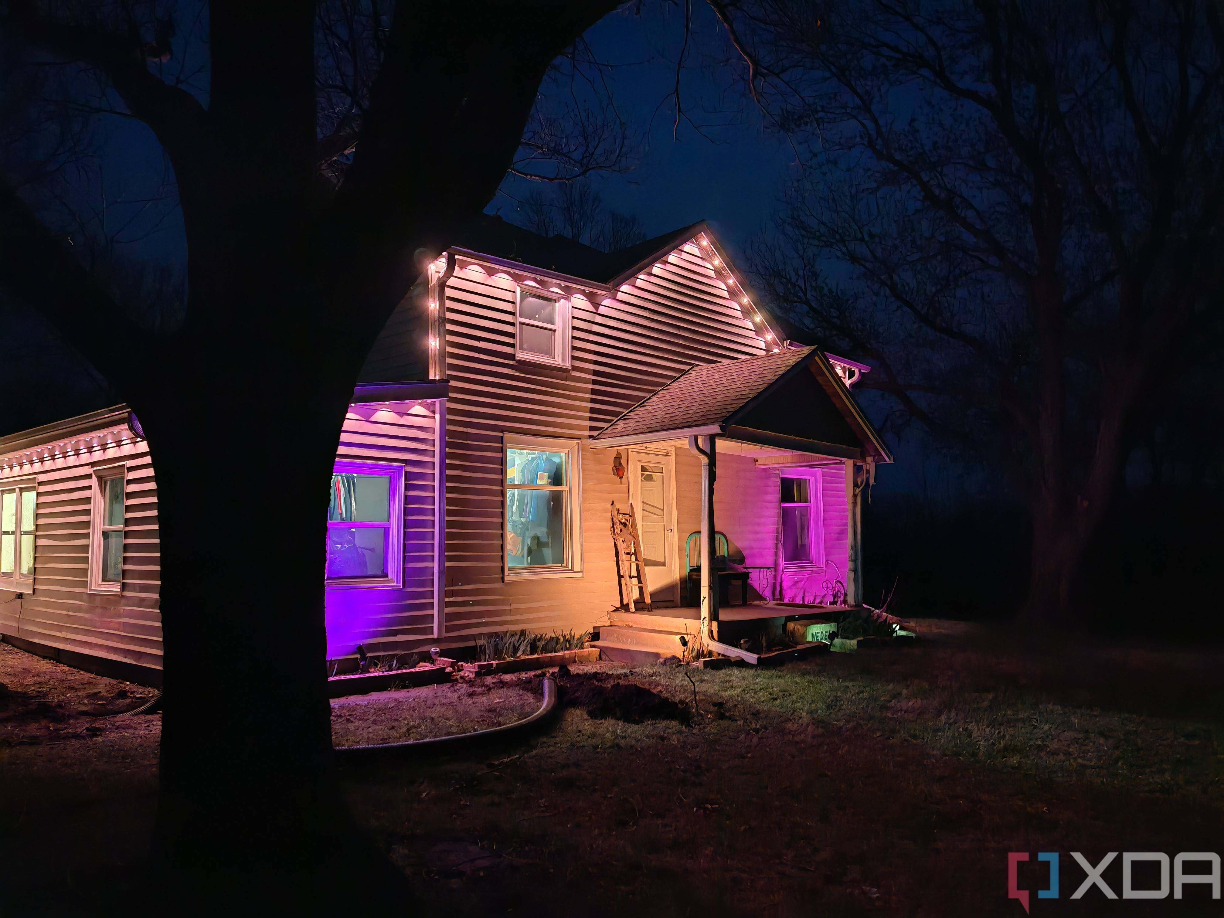 Photo of a house at night with exterior lighting