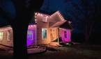 Photo of a house at night with exterior lighting