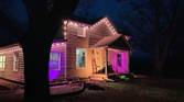 Photo of a house at night with exterior lighting