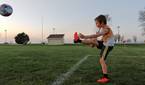 Child playing soccer photo taken using manual shutter